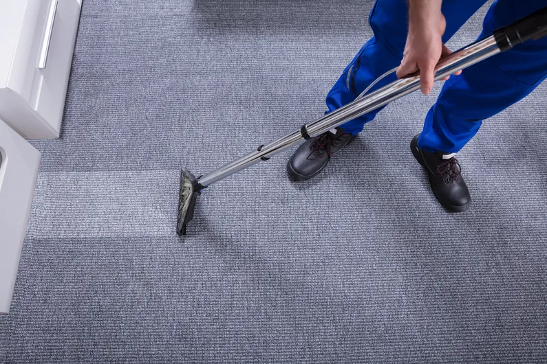Workers using professional water damage extraction equipment.
