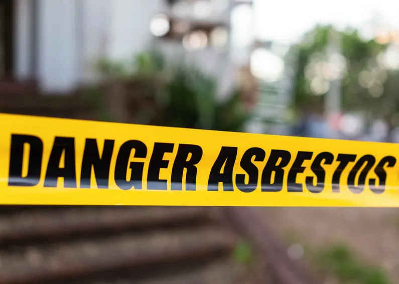A worker removing Asbestos safely.